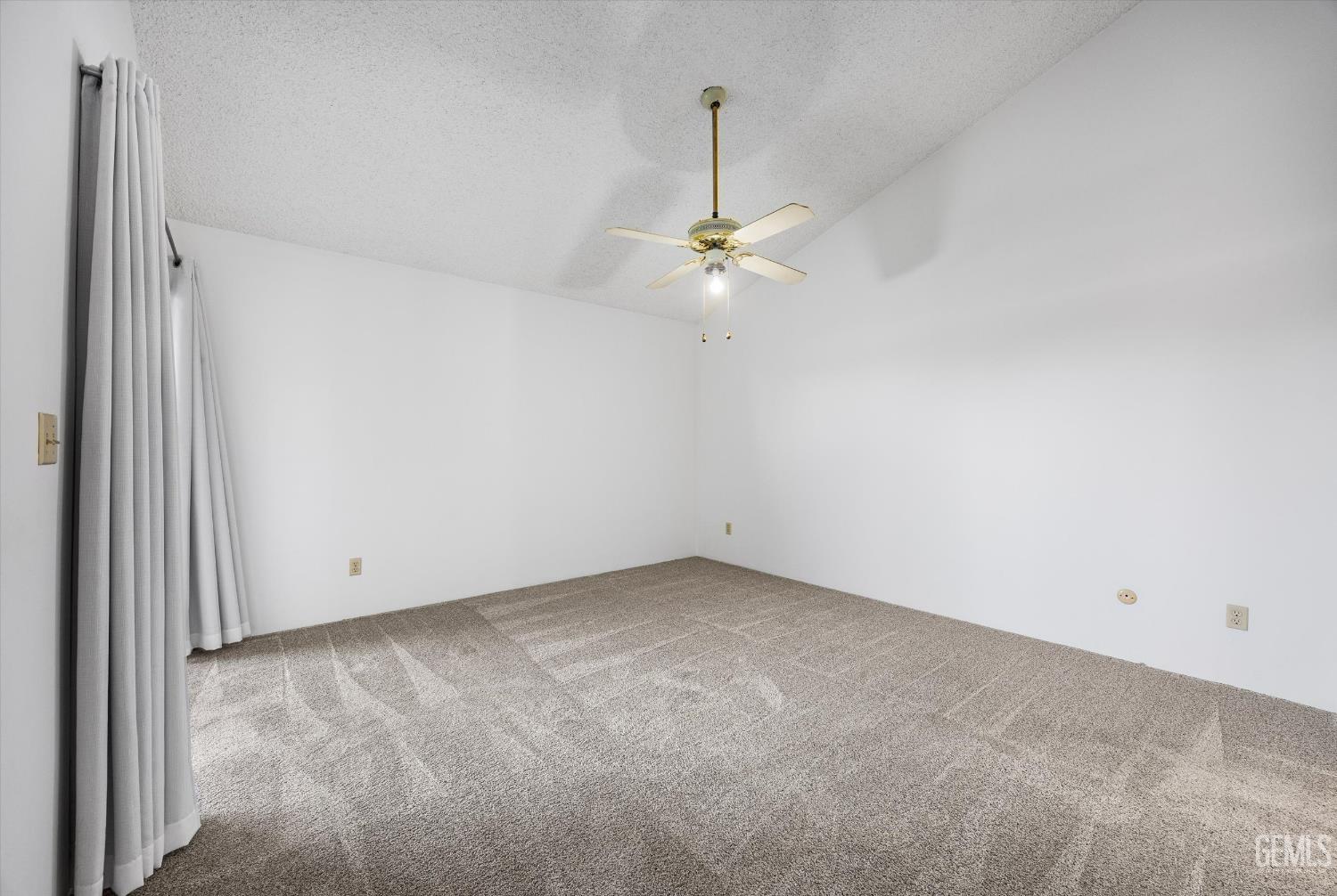 Undisclosed Address Bakersfield, CA 93308 - Photo 20 of 37 an empty room with a chandelier fan