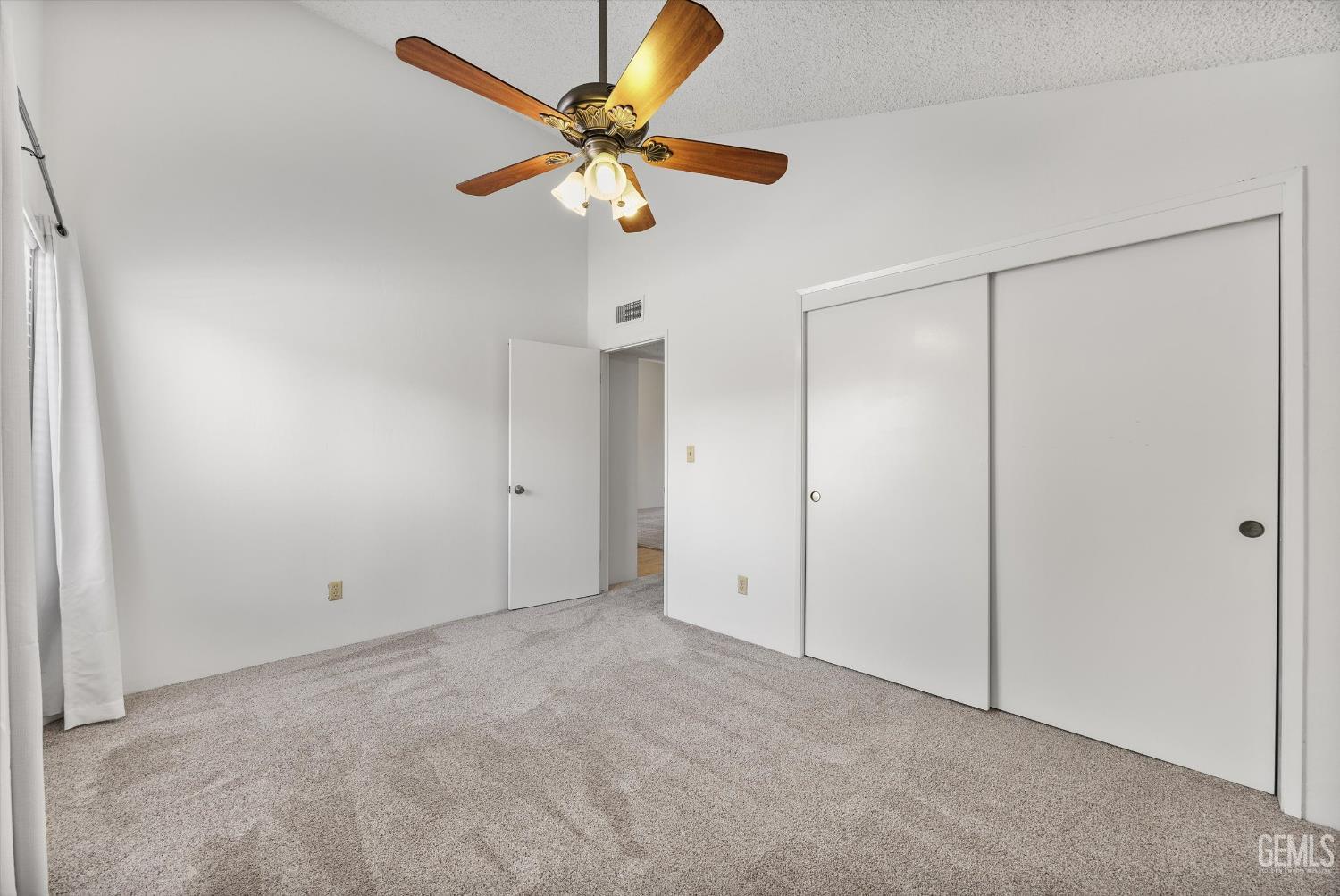 Undisclosed Address Bakersfield, CA 93308 - Photo 26 of 37 an empty room with a ceiling fan and a window