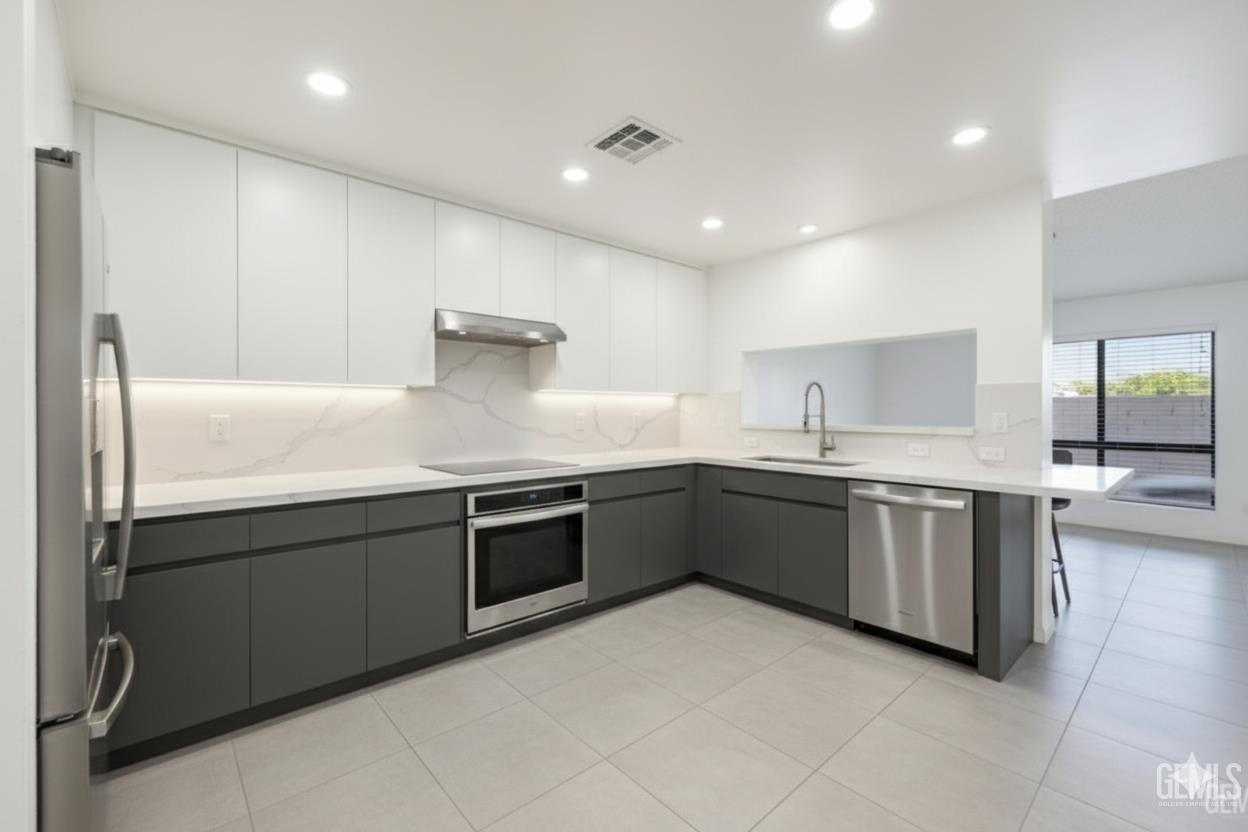 Undisclosed Address Bakersfield, CA 93308 - Photo 36 of 37 a large kitchen with a large counter top sink and stove