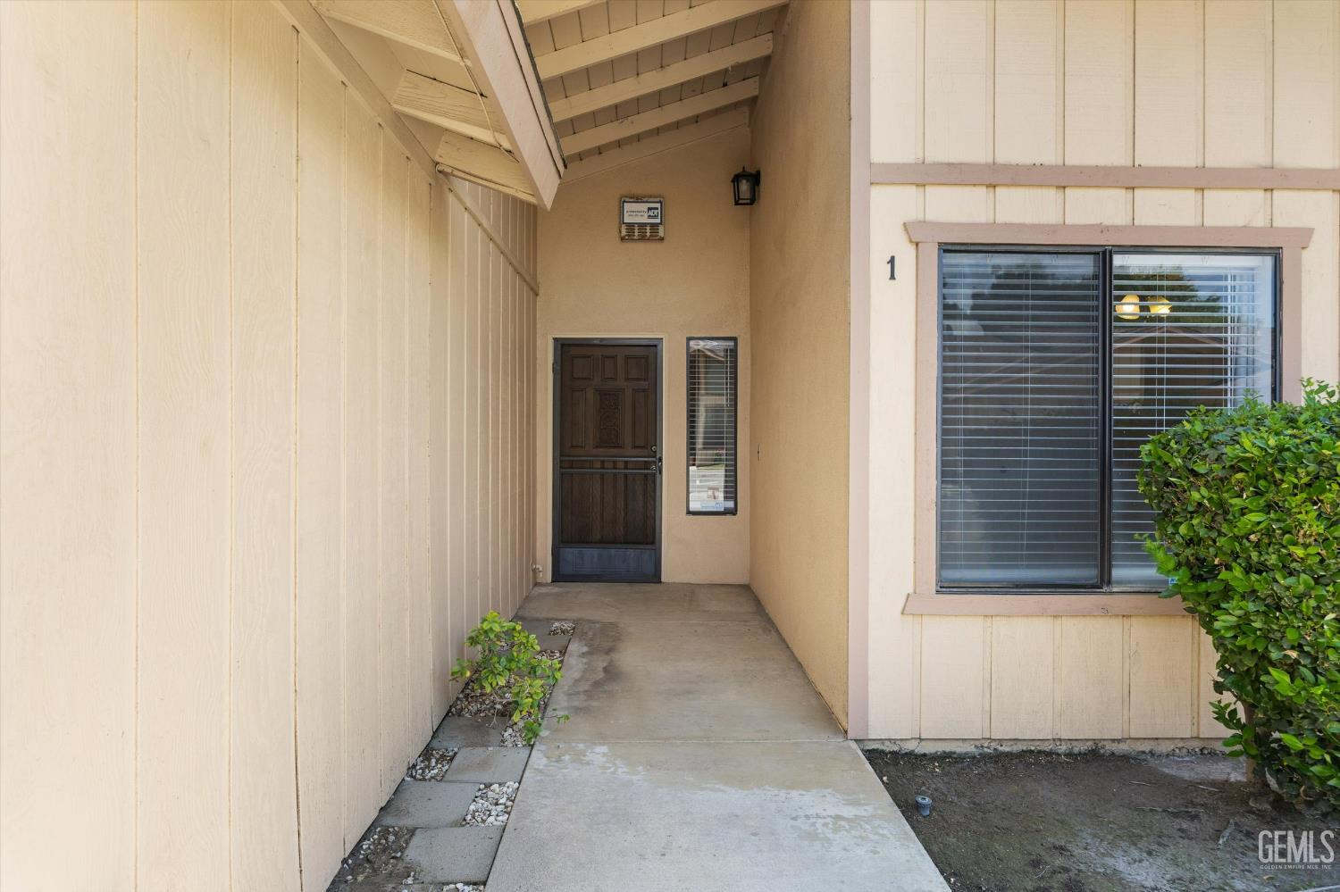 Undisclosed Address Bakersfield, CA 93308 - Photo 4 of 37 a front view of a house with a garage