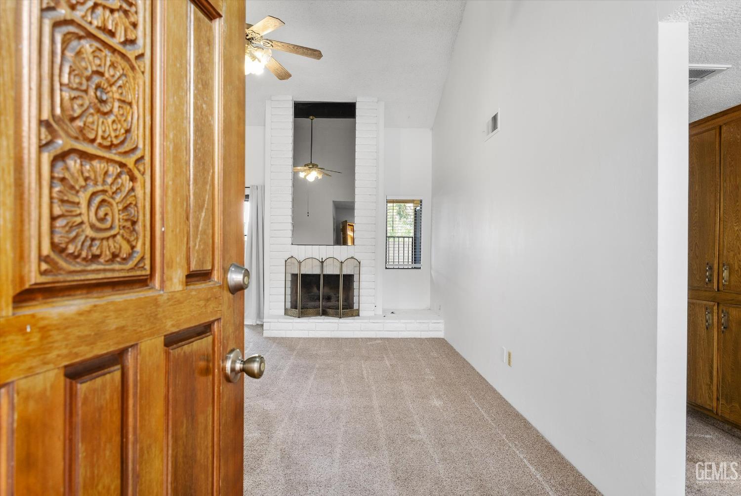 Undisclosed Address Bakersfield, CA 93308 - Photo 5 of 37 a view of a hallway with wooden floor and a bathroom