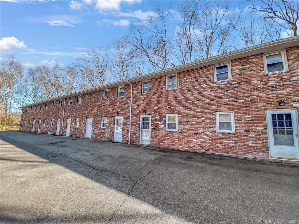 3 Rathbun Road, Unit 7 East Lyme, CT 06357 - Photo 1 of 1 a front view of a house with a yard and garage