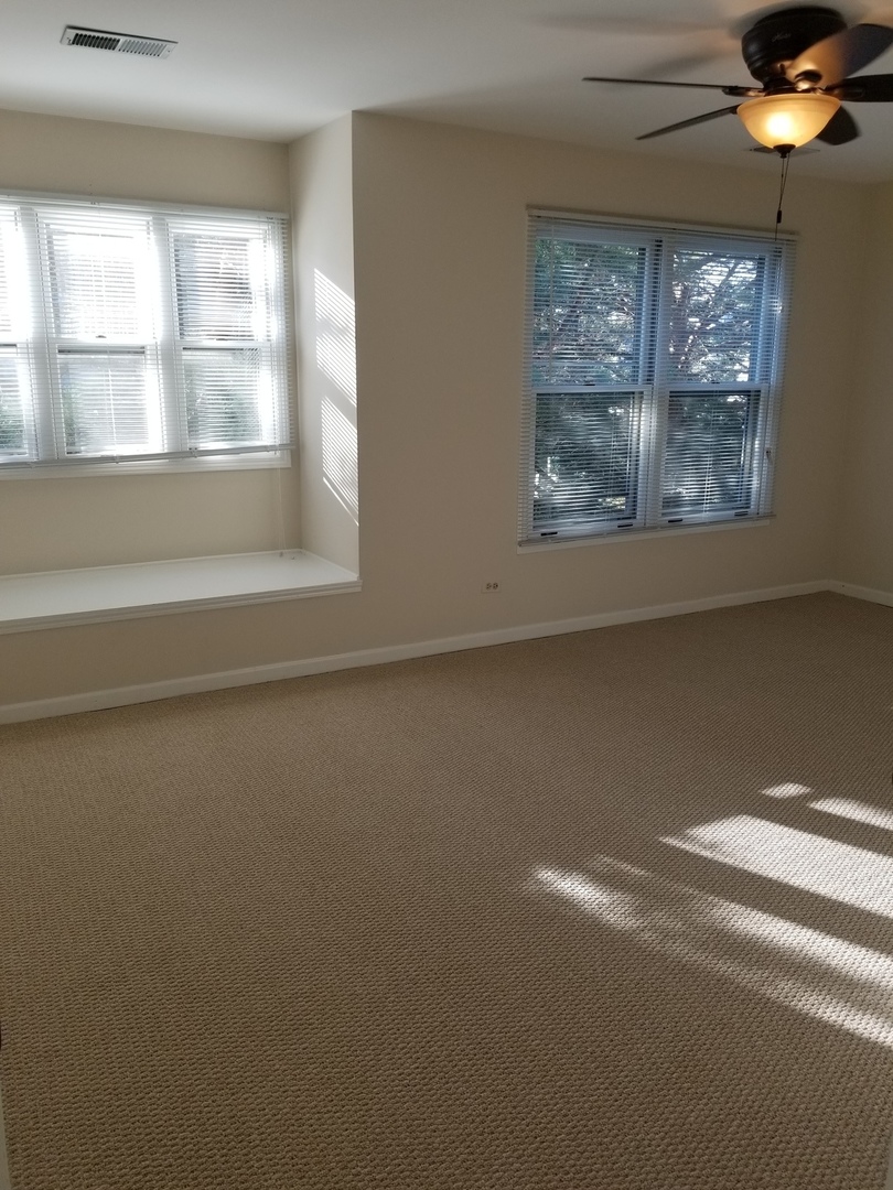 1280 Rhodes Lane, Unit 1280 Naperville, IL 60540 - Photo 11 of 11 a view of empty room with window and chandelier fan