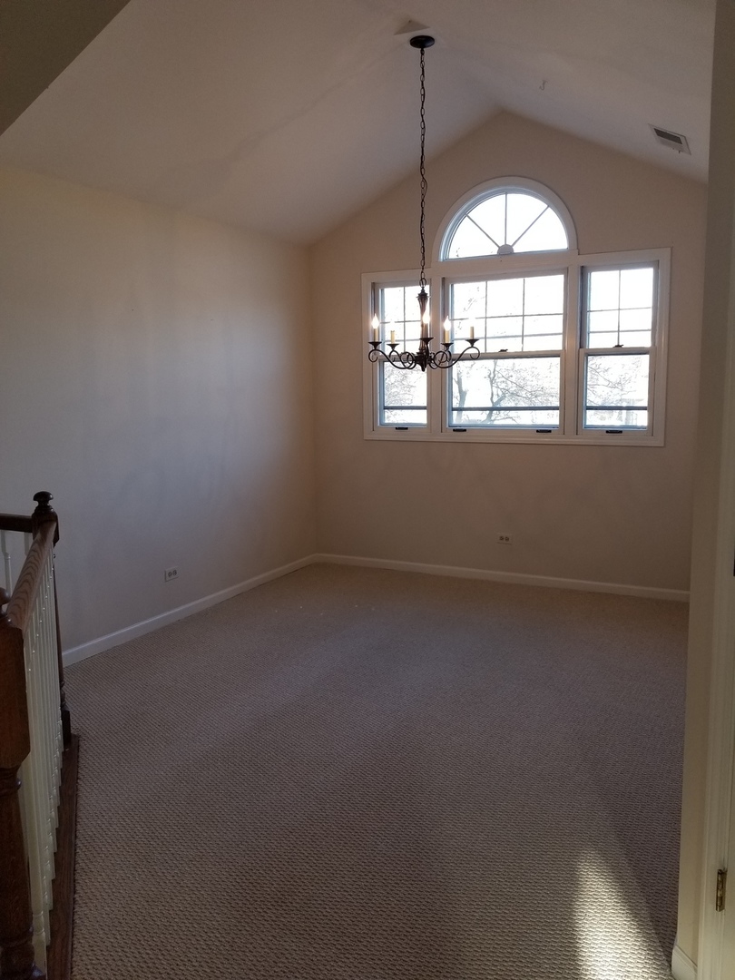 1280 Rhodes Lane, Unit 1280 Naperville, IL 60540 - Photo 5 of 11 an empty room with a window