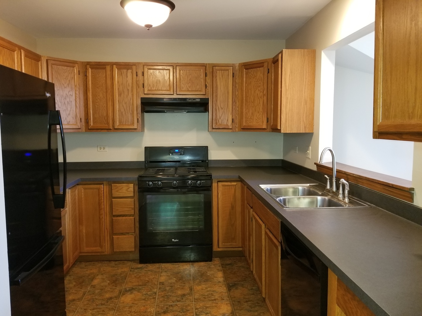 1280 Rhodes Lane, Unit 1280 Naperville, IL 60540 - Photo 9 of 11 a kitchen with a sink stove and refrigerator