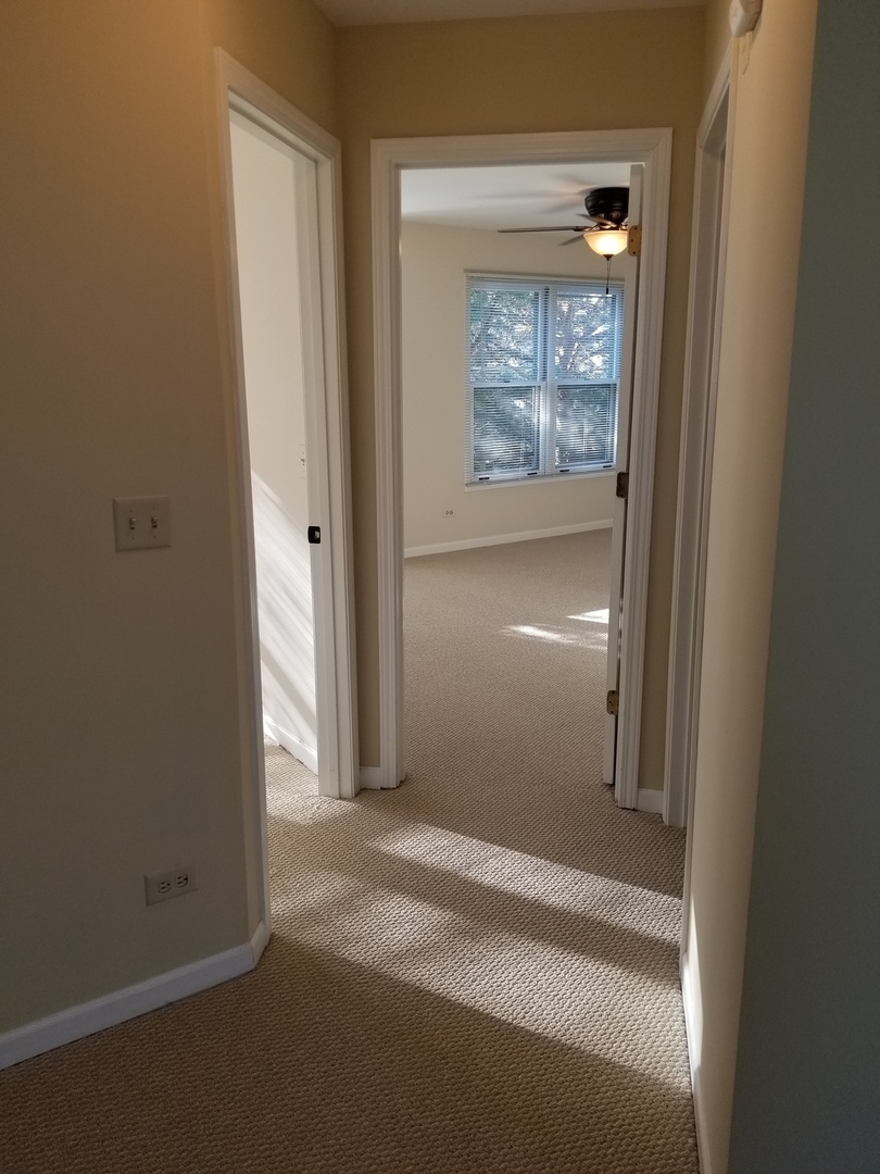 1280 Rhodes Lane, Unit 1280 Naperville, IL 60540 - Photo 10 of 11 a view of hallway with wooden floor