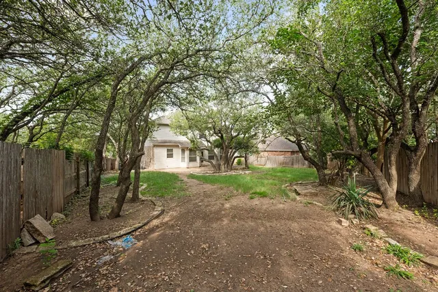 a view of backyard of house with green space