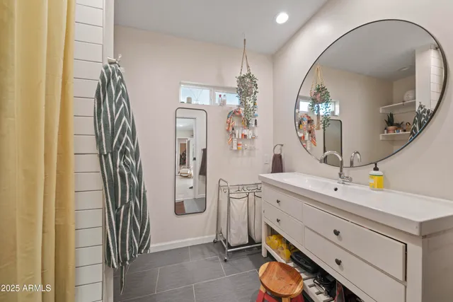 a bathroom with a double vanity sink mirror and toilet
