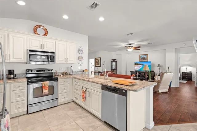 a kitchen with a stove sink and microwave