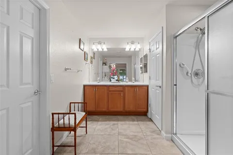 a bathroom with a granite countertop shower sink mirror and toilet