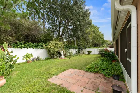 a view of a house with a yard and sitting area