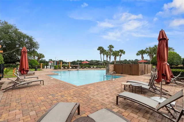 a view of a house with swimming pool and a yard