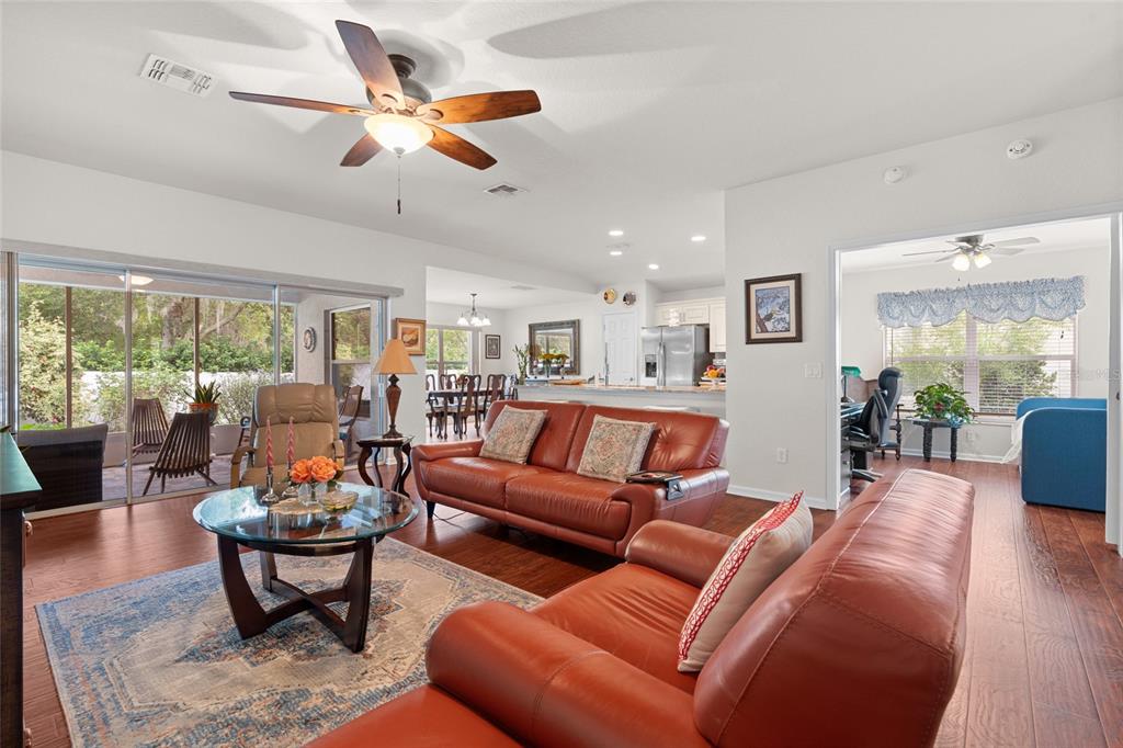 4683 Southwest 40th Place Ocala, FL 34474 - Photo 3 of 43 a living room with furniture ceiling fan and a large window