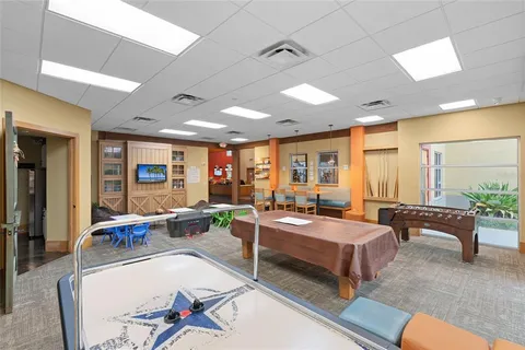 a living room with furniture and a bookshelf