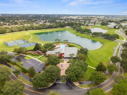a view of a swimming pool with a table and chairs in the patio