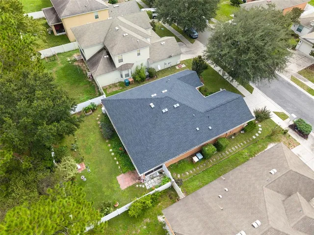 an aerial view of a house with a swimming pool