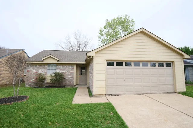 a view of a house with a yard and garage