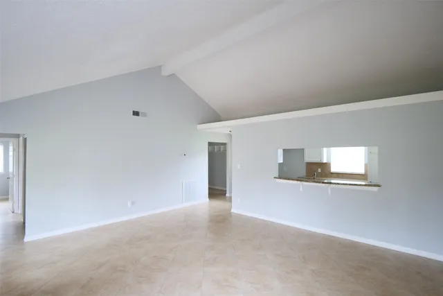 a view of a livingroom with an empty space and window