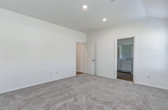 a view of an empty room and a window