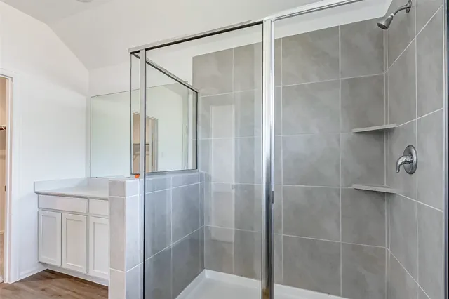 a bathroom with a glass shower door