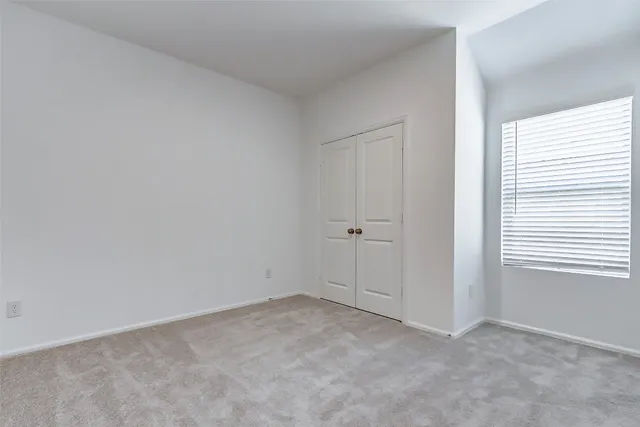 a view of an empty room and a window