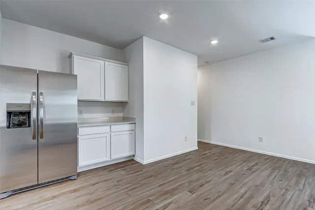 a view of a kitchen with a sink and refrigerator