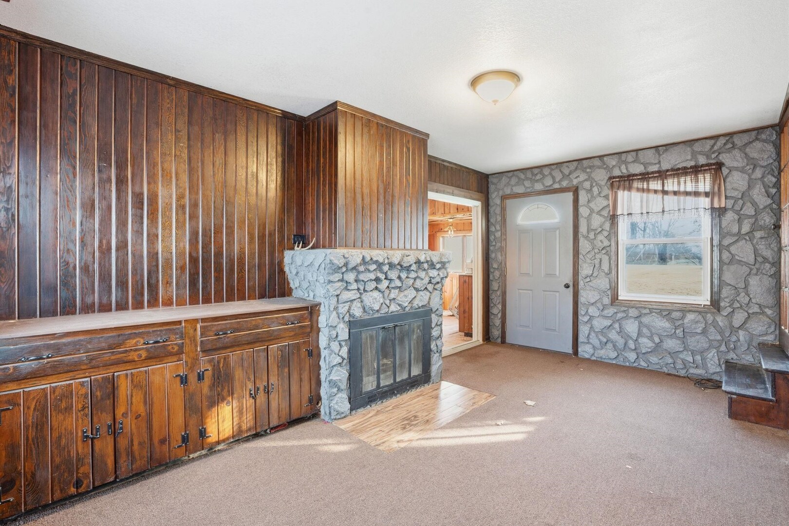5029 69th Avenue Milan, IL 61264 - Photo 12 of 25 a view of an empty room with a fireplace and a window