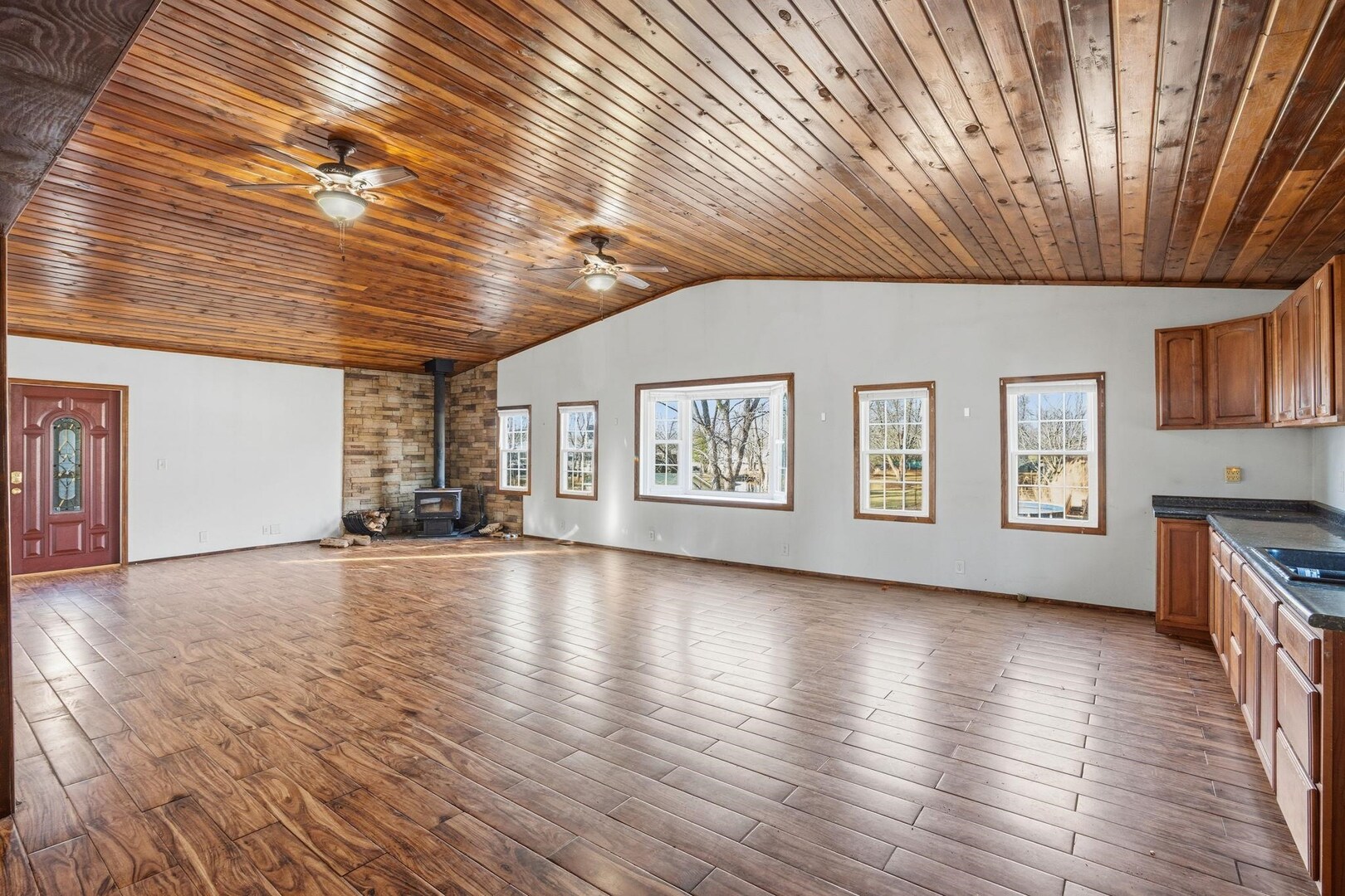 5029 69th Avenue Milan, IL 61264 - Photo 6 of 25 a view of an empty room with a window and wooden floor