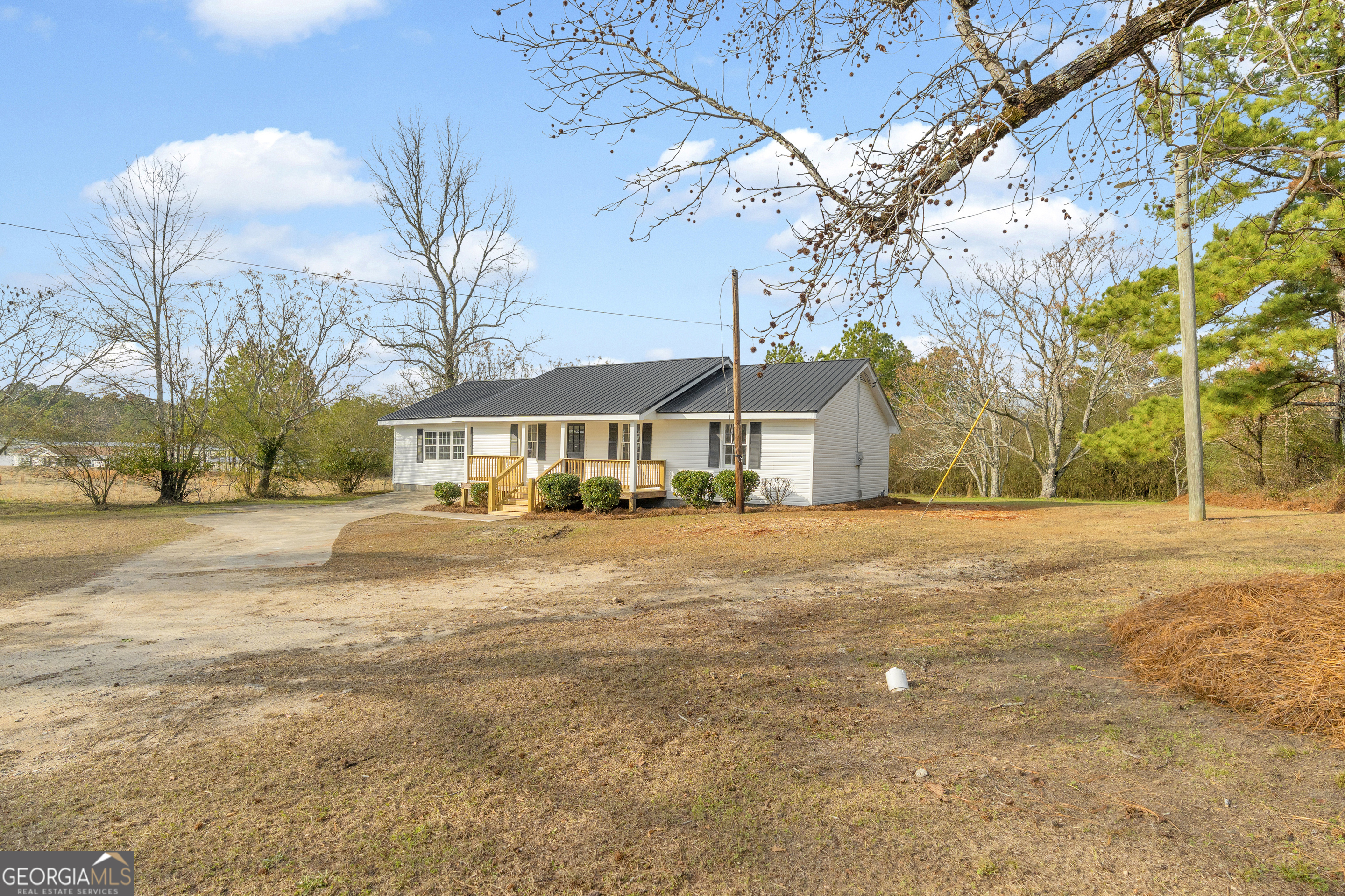 1160 Planing Mill Road Greensboro, GA 30642 - Photo 13 of 76 a front view of a house with a yard and trees