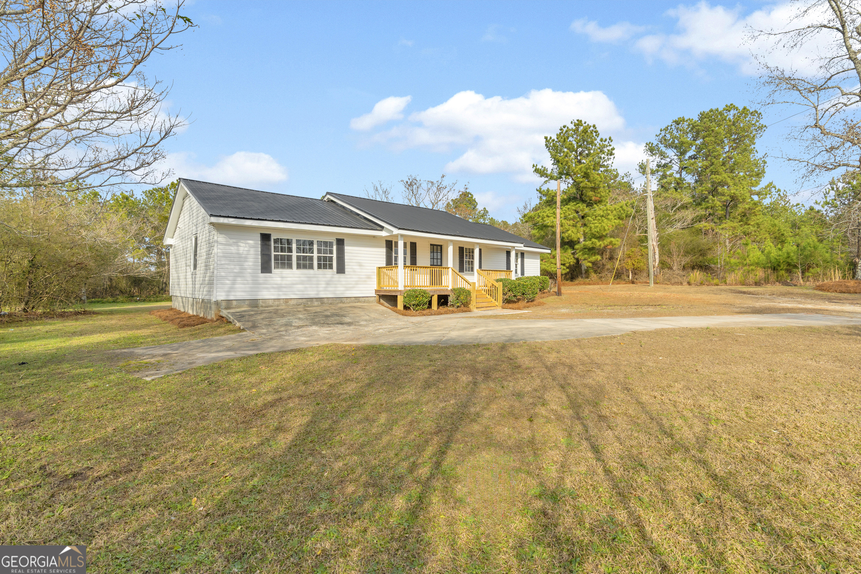 1160 Planing Mill Road Greensboro, GA 30642 - Photo 15 of 76 a front view of a house with a yard