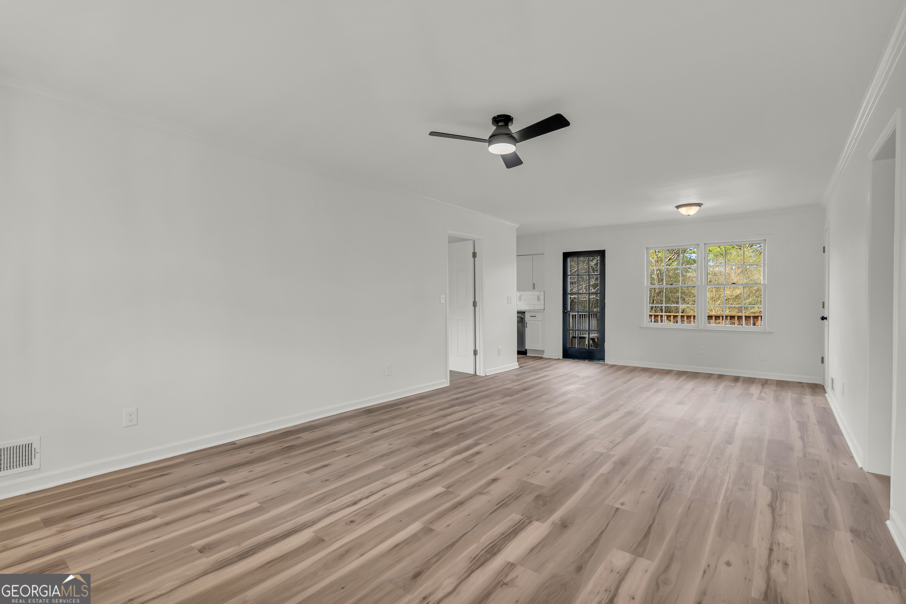 1160 Planing Mill Road Greensboro, GA 30642 - Photo 25 of 76 wooden floor in an empty room with a window