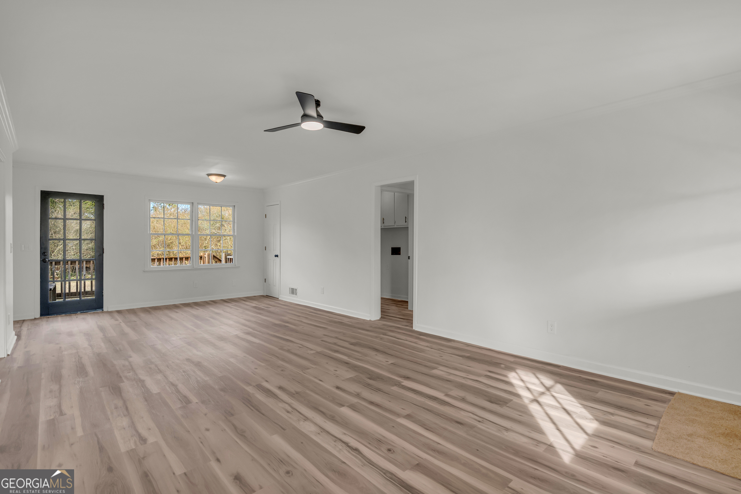 1160 Planing Mill Road Greensboro, GA 30642 - Photo 28 of 76 a view of empty room with wooden floor and fan