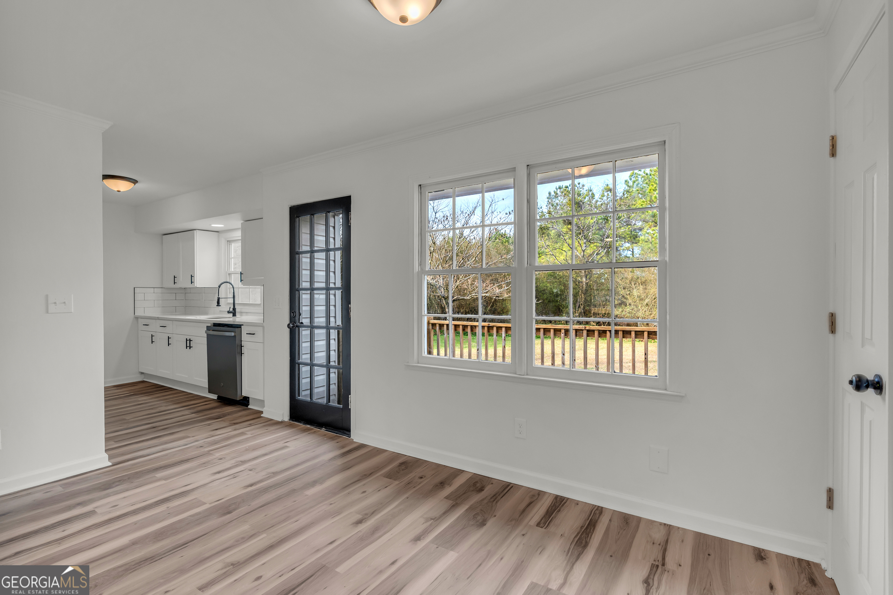 1160 Planing Mill Road Greensboro, GA 30642 - Photo 30 of 76 a view of a kitchen with wooden floor and windows