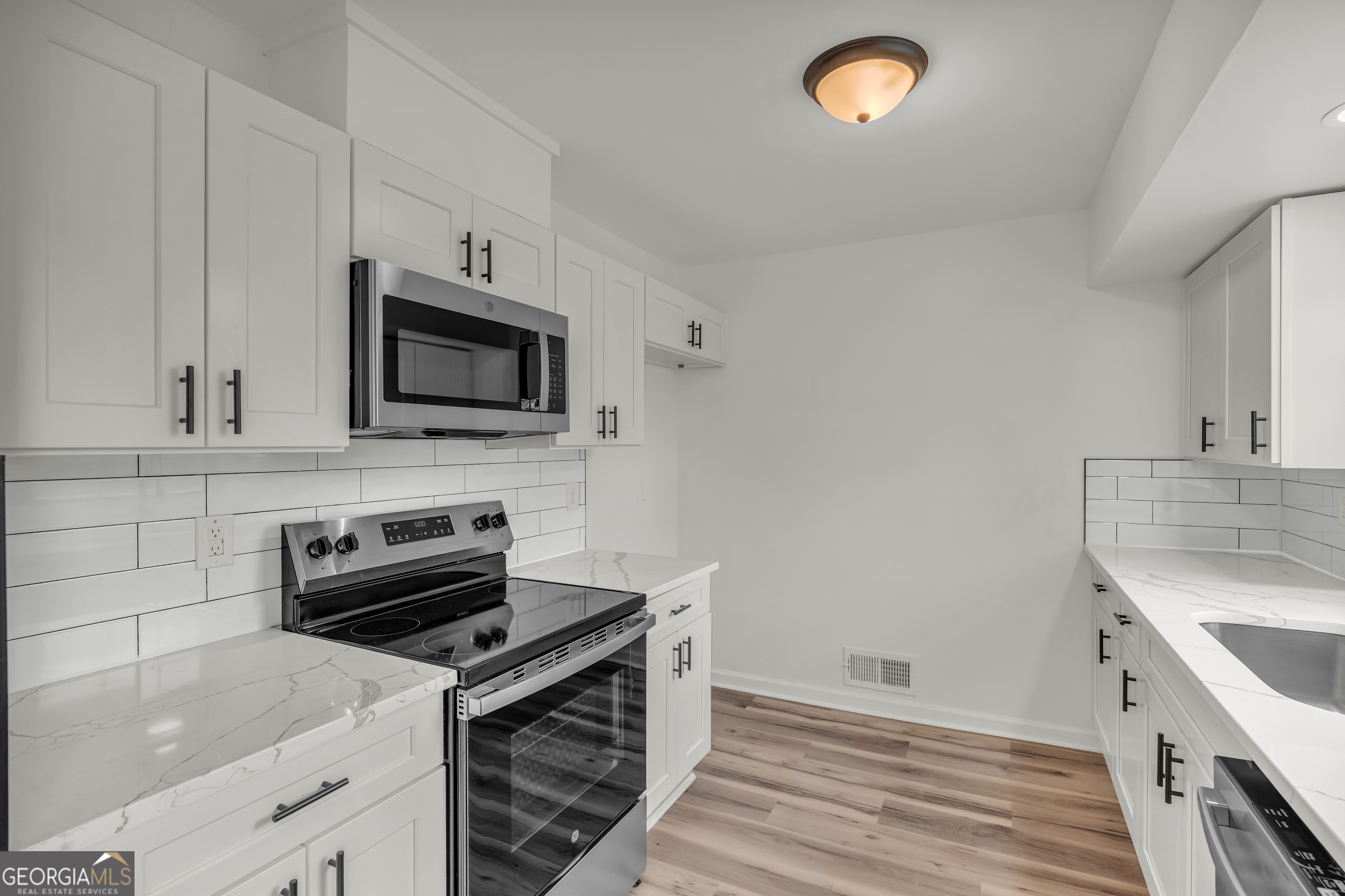 1160 Planing Mill Road Greensboro, GA 30642 - Photo 32 of 76 a kitchen with granite countertop a sink and a stove top oven