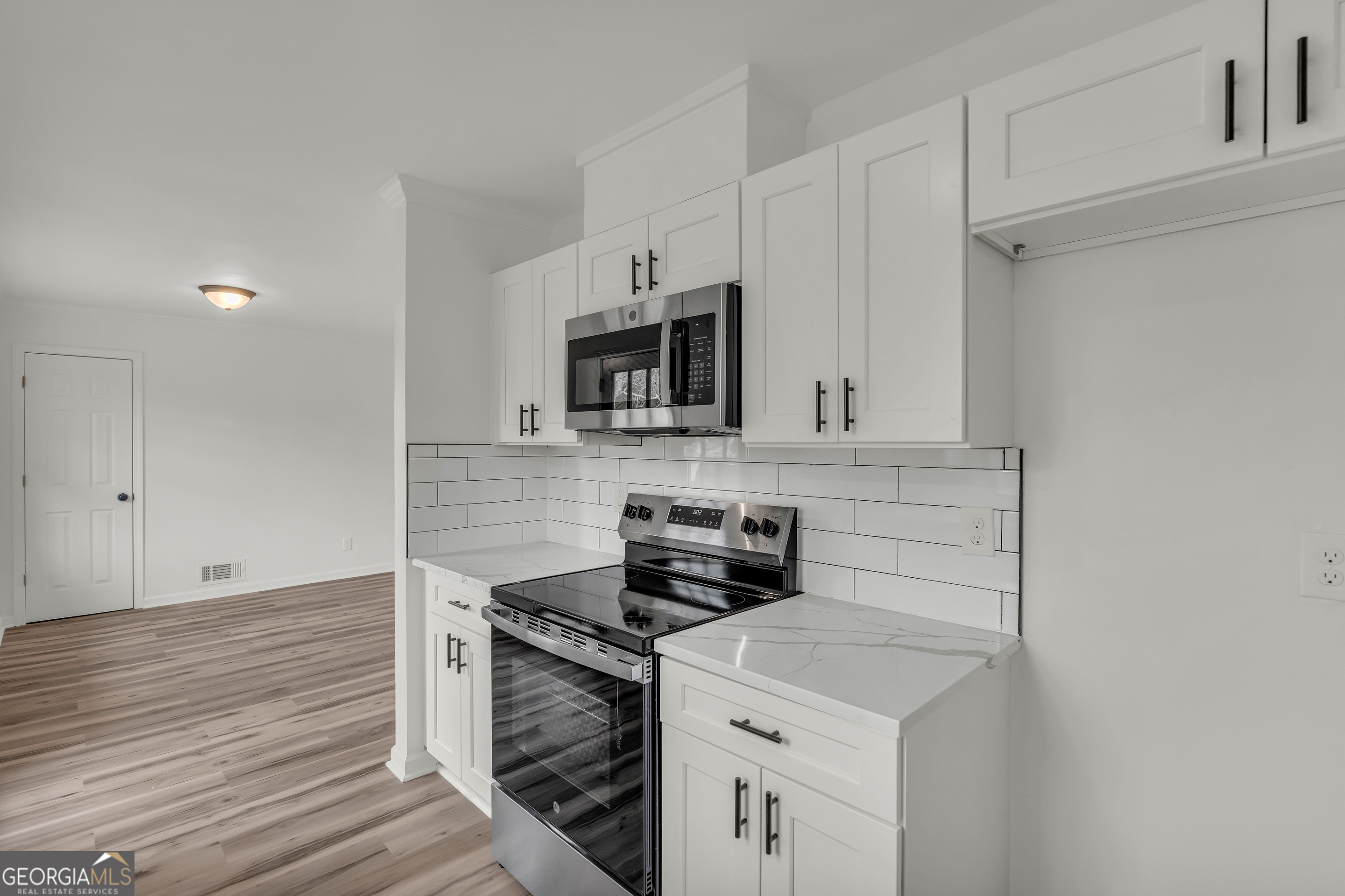 1160 Planing Mill Road Greensboro, GA 30642 - Photo 35 of 76 a kitchen with stainless steel appliances a stove and a microwave
