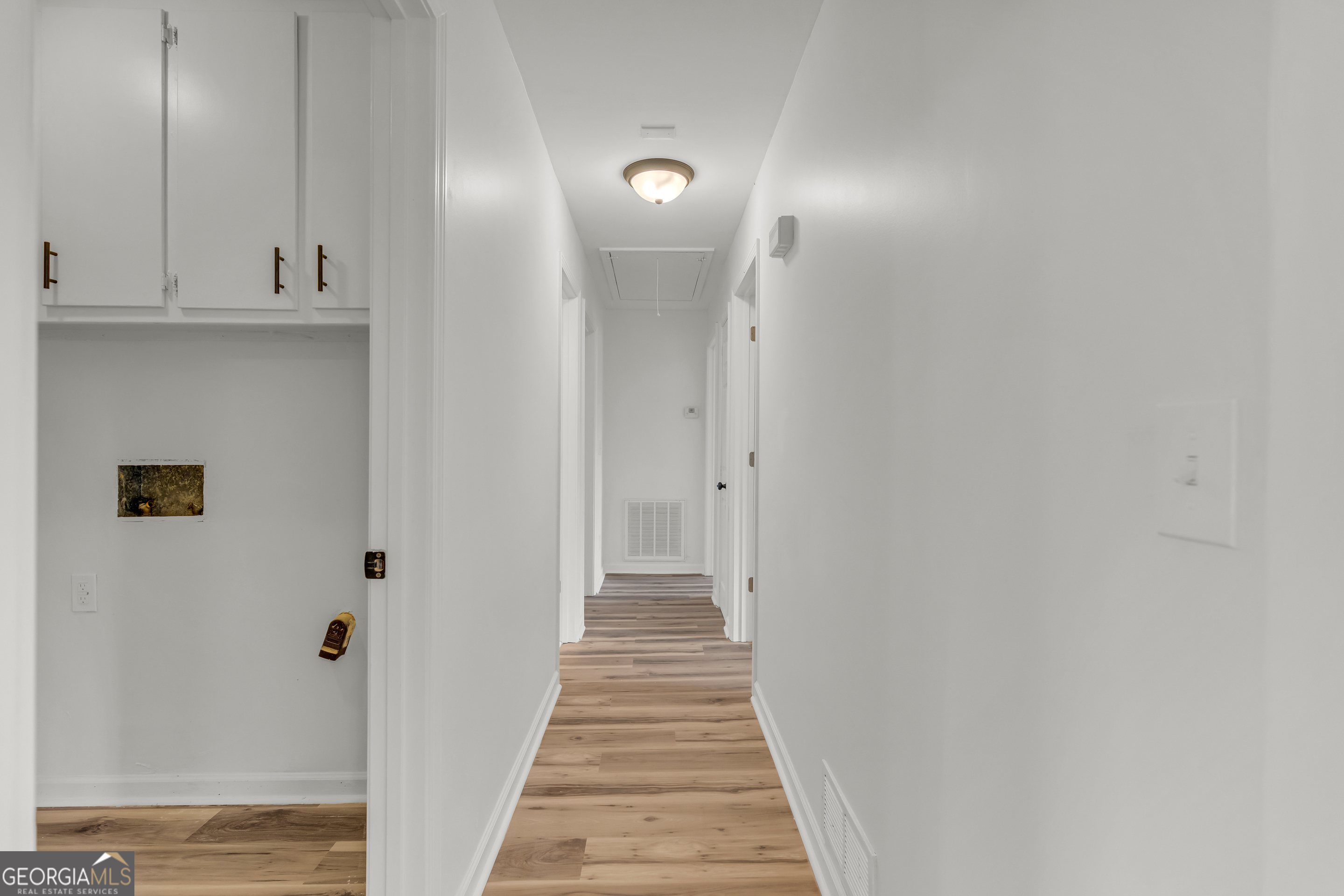 1160 Planing Mill Road Greensboro, GA 30642 - Photo 39 of 76 a view of a hallway with wooden floor and staircase