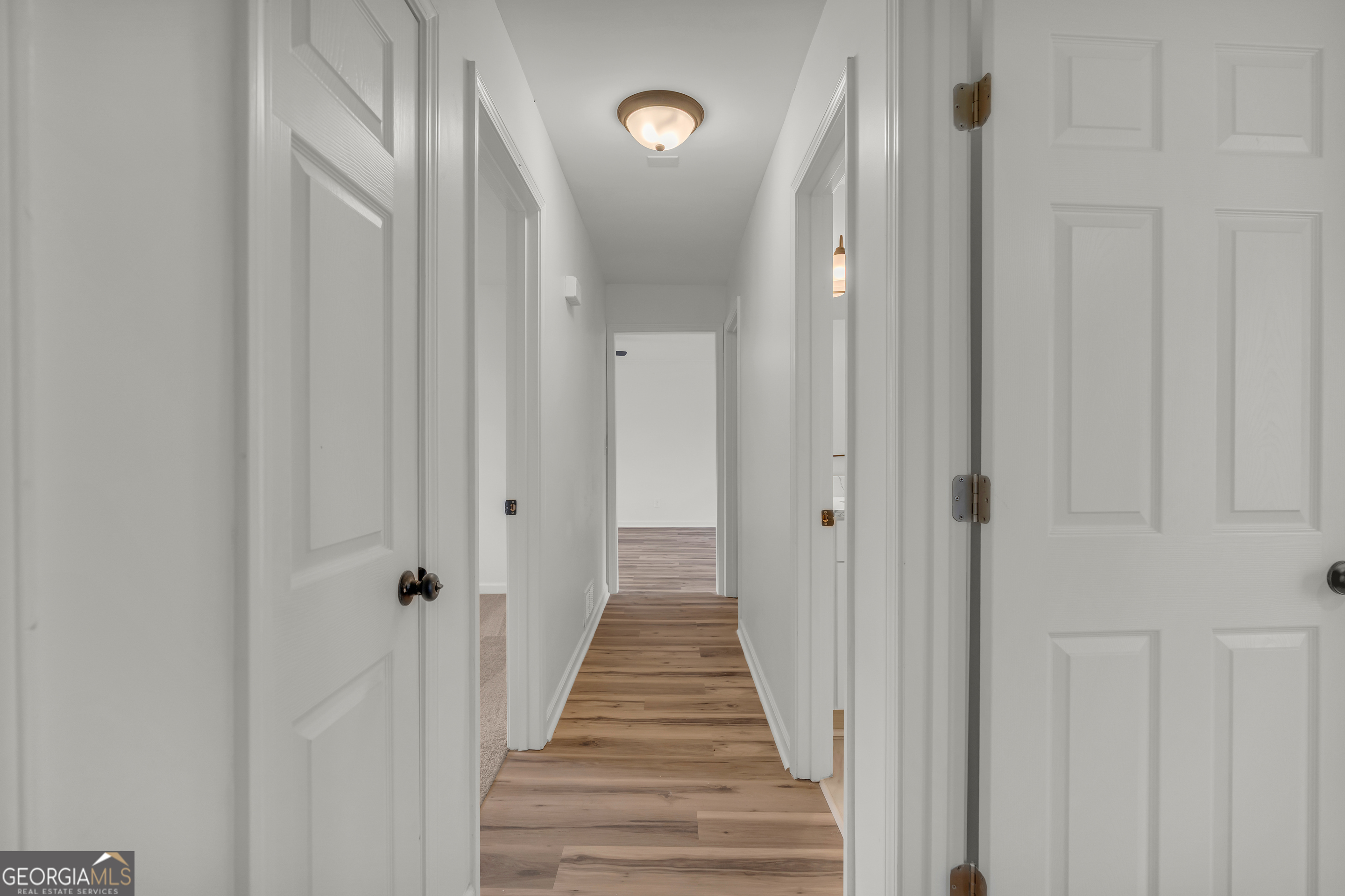 1160 Planing Mill Road Greensboro, GA 30642 - Photo 40 of 76 a view of a hallway with wooden floor and stairs