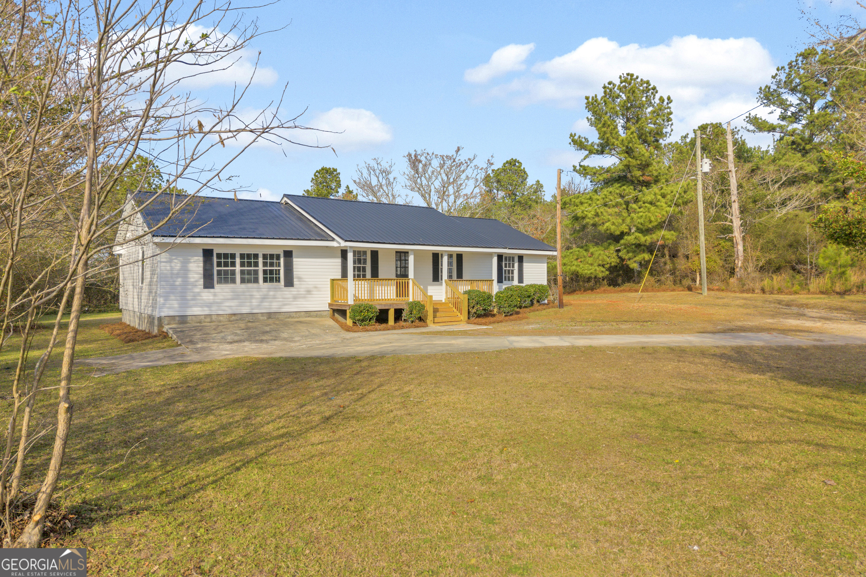 1160 Planing Mill Road Greensboro, GA 30642 - Photo 4 of 76 a front view of a house with a yard and swimming pool
