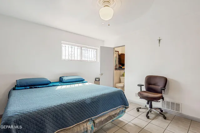 a bedroom with a bed and a chair