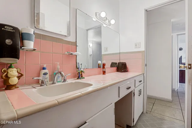 a bathroom with a sink and a mirror