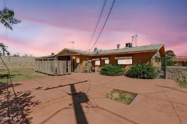a backyard of a house with shaded area