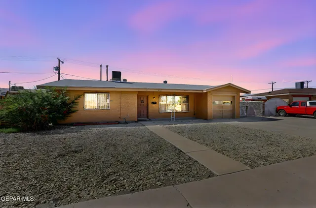 a view of a house next to a yard