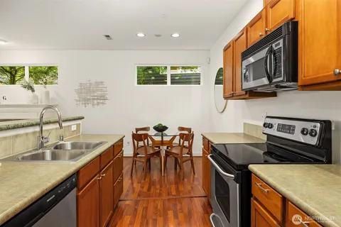 a kitchen with stainless steel appliances granite countertop a sink stove and microwave