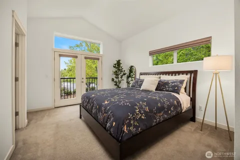 a bed sitting in a bedroom next to a window