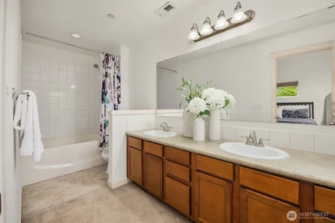 a bathroom with a tub shower and a sink