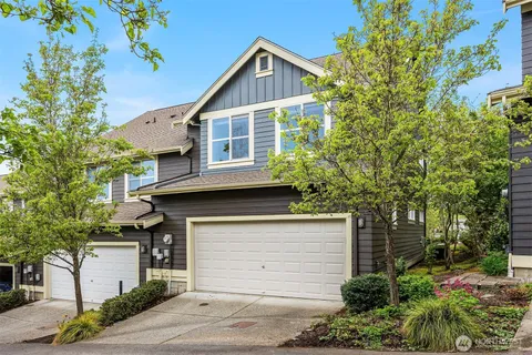 a view of a house with a yard and garage