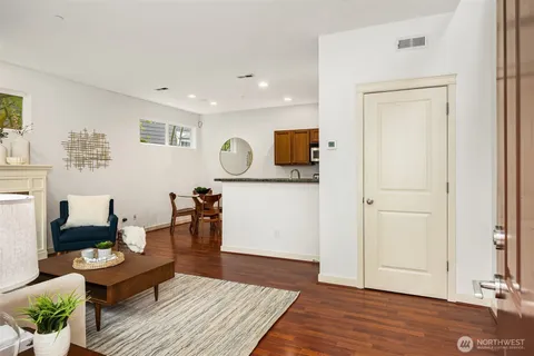 a living room with furniture and a wooden floor