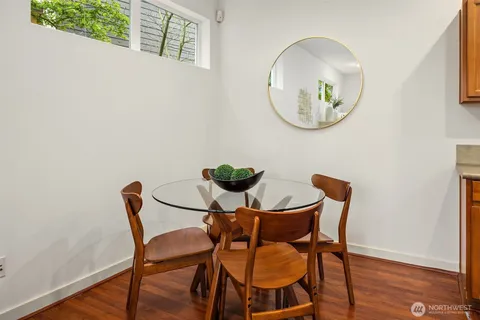 a view of a dining room with furniture and wooden floor