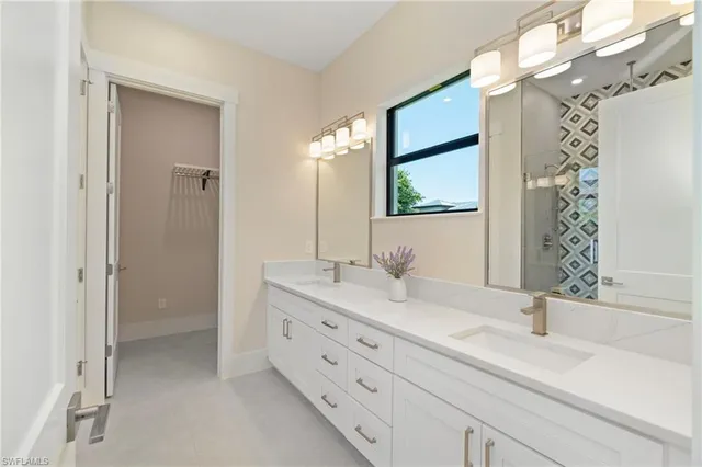 a bathroom with a double vanity sink mirror and shower