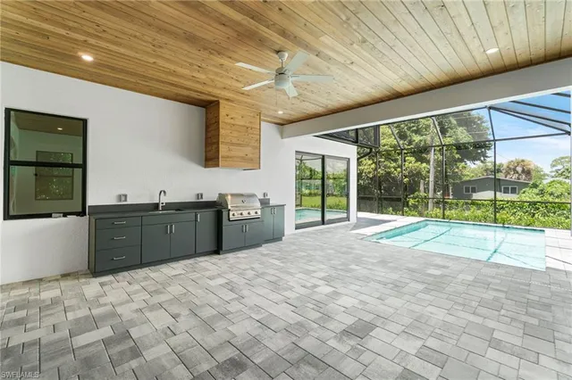 a view of a kitchen with a sink and wooden cabinets